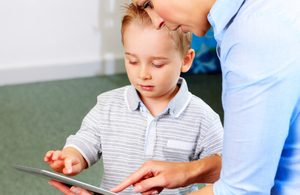 Child and therapist with handheld computer