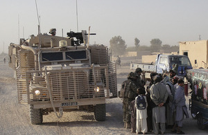 British soldiers dismount from a Mastiff armoured patrol vehicle to chat with locals in Lashkar Gah