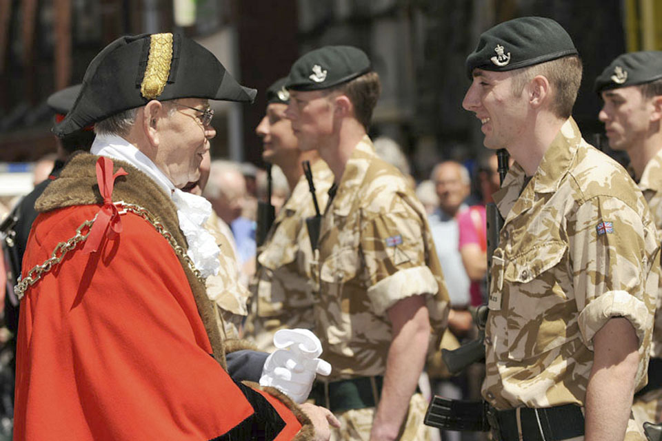 Les Phillips, the Mayor of Dorchester, meets a soldier from 4 RIFLES 