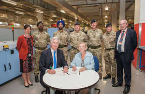 Royal Mail CEO Moya Green signing the Armed Forces Covenant with Secretary of State for Defence Michael Fallon