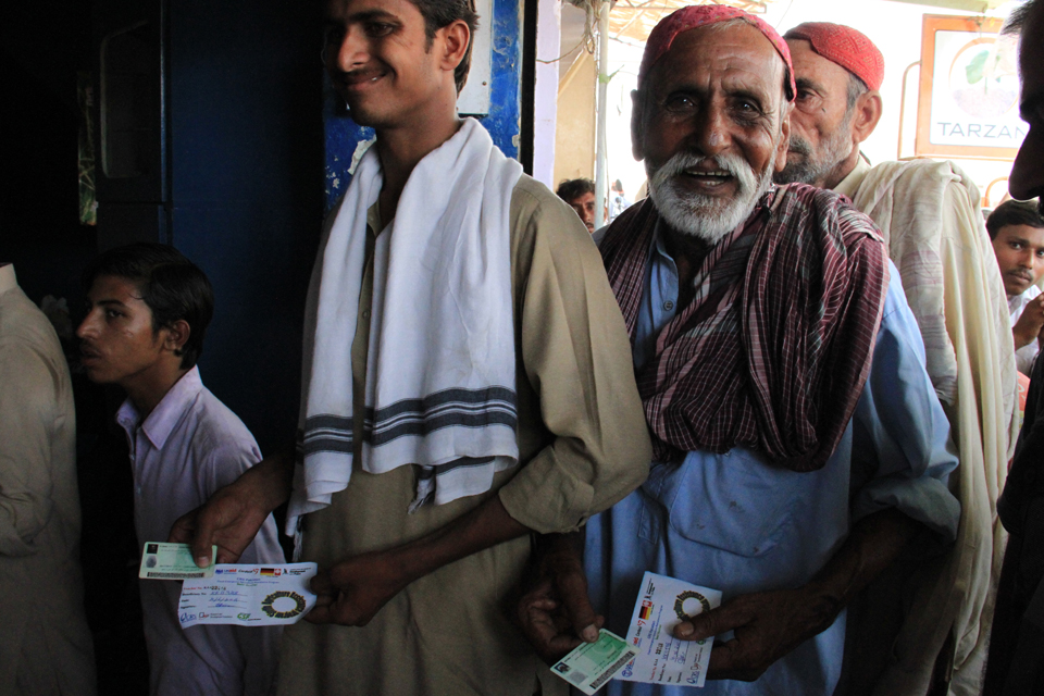 Men stand in line with their vouchers. Picture: Vicki Francis/DFID