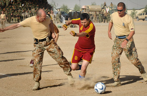 An Afghan player gains control of the ball during the game against Denmark