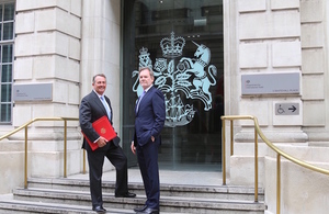 Secretary of State Dr Liam Fox welcomes chief trade negotiation adviser Crawford Falconer outside the Department for International Trade