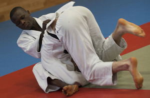 Trooper Emmanuel Nartey holds down an opponent during a judo training session