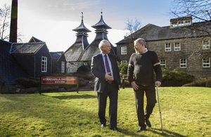 Francis Maude speaking to social entrepreneur Bruce Gunn at Strathisla distillery.