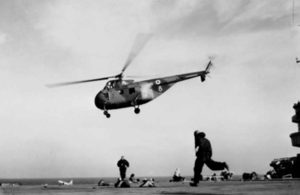 A Westland Whirlwind helicopter of the joint Royal Air Force/Army unit leaving HMS OCEAN with troops for Port Said.