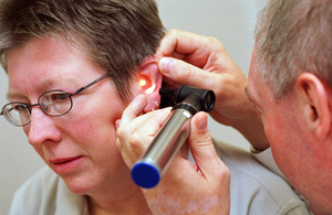 Woman having consultation with doctor. Ear examination.