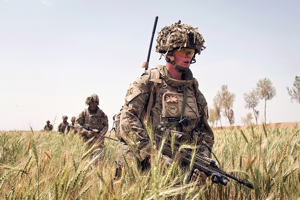 British soldiers patrol through a wheat field in Yakchal, Afghanistan