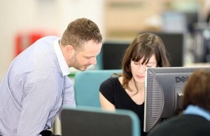 people at desk with computer