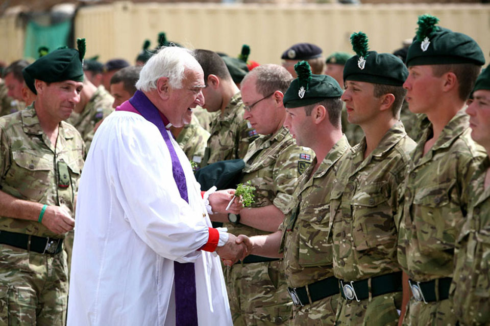 Lord Eames presents a soldier from 1st Battalion The Royal Irish Regiment with shamrocks
