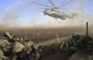 Troops protect their eyes from the debris kicked up by a descending helicopter