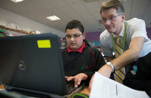 Pupil and teacher working together on a computer