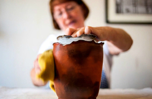 Anne finishing a homemade pottery piece