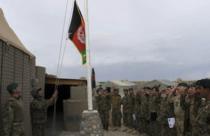 The Afghan flag is raised at a patrol base north of Gereshk in Helmand province (library image)