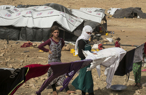 Displaced Kurdish Yazidis photographed on Mount Sinjar in August after receiving UK aid shelter kits via air drops in the region. Picture: Emilien Urbano/MYOP