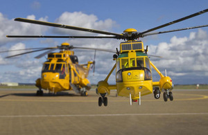 Corgi's 1:72 scale die-cast metal Westland Sea King HAR3 RAF Search and Rescue helicopter alongside the real thing (images manipulated)