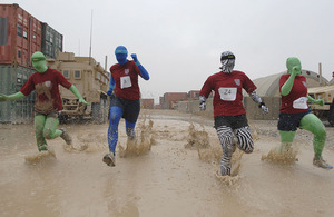 Half-marathon relay race runners in fancy dress at Headquarters Task Force Helmand in Lashkar Gah