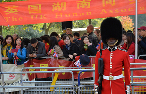A soldier from the Scots Guards stands on the procession route in front of spectators