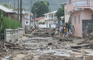 St Lucians carefully negotiate the chaos of rubble, mud and craters where a road ran through this village just days ago