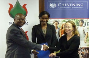 Managing Director of Namcor, Obeth Kandjoze, Alina Haidula, Chevening recipient, and HE Marianne Young exchanging the MoU