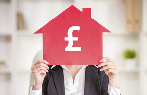 Woman holding house sign