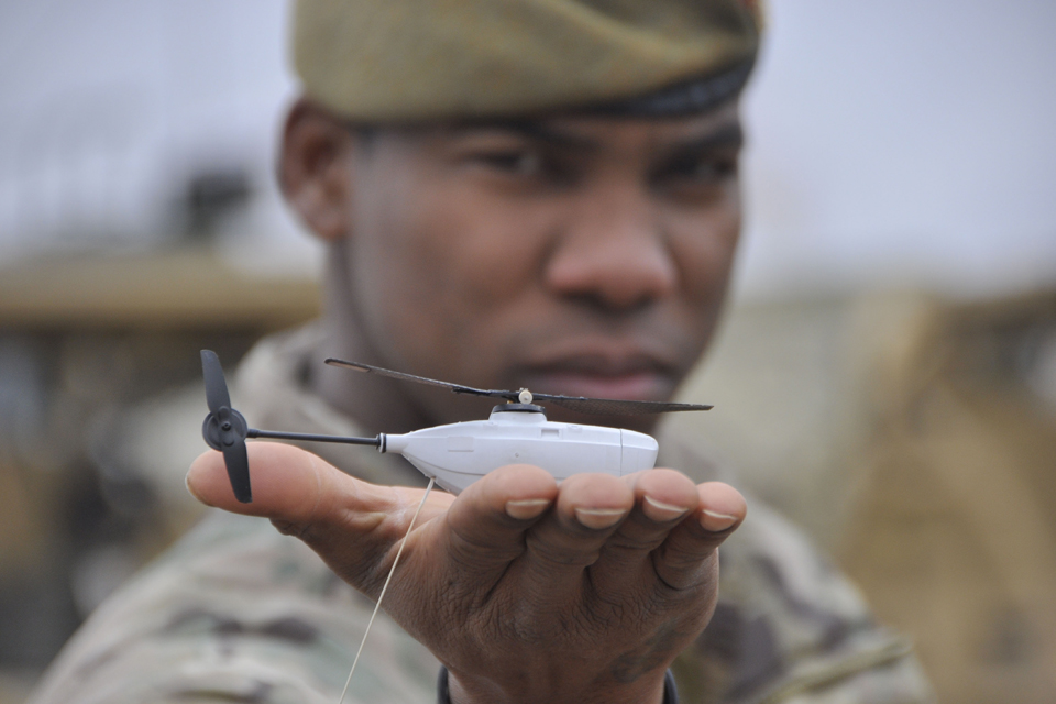 Soldier holding a Black Hornet Nano Unmanned Air Vehicle