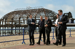 David Cameron, George Osborne and members of the East Sussex Fire and Rescue Service in front on Eastbourne Pier