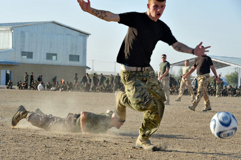 A British player successfully wrestles the ball away from an American opponent