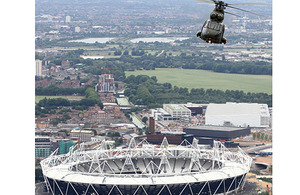 An RAF Puma flying over the 2012 Olympic Stadium. Puma and Lynx helicopters, operating from HMS Ocean, are likely to support airspace security during the Games