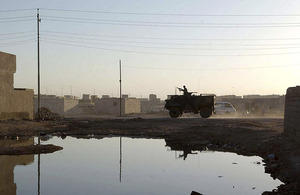 A Saxon amoured personnel carrier provides support to British foot patrols in Basra City in 2003 (stock image)