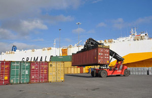 Image of port shipping containers being moved.