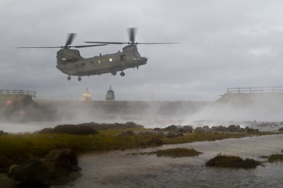 An RAF Chinook with an underslung load of bagged aggregate 