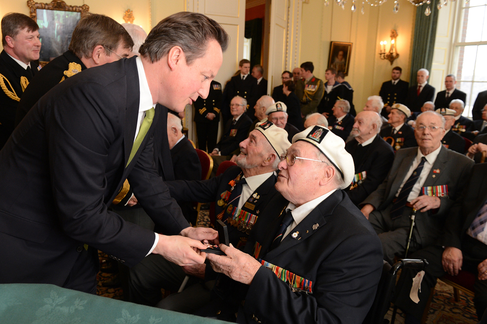 Prime Minister David Cameron presents a veteran with an Arctic Star medal