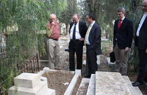 Examining damage of graves and crosses at the Protestant Cemetry