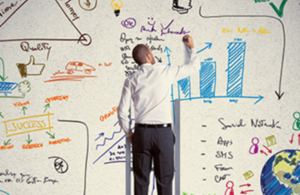 Man jotting down inspirations on a whiteboard