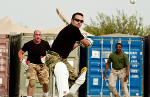A Royal Marine prepares to hit the ball for six in Sangin