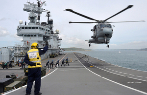 A Merlin Mk2 helicopter hovers above the flight deck of HMS Illustrious (library image) [Picture: Petty Officer Airman (Photographer) Ray Jones, Crown copyright]