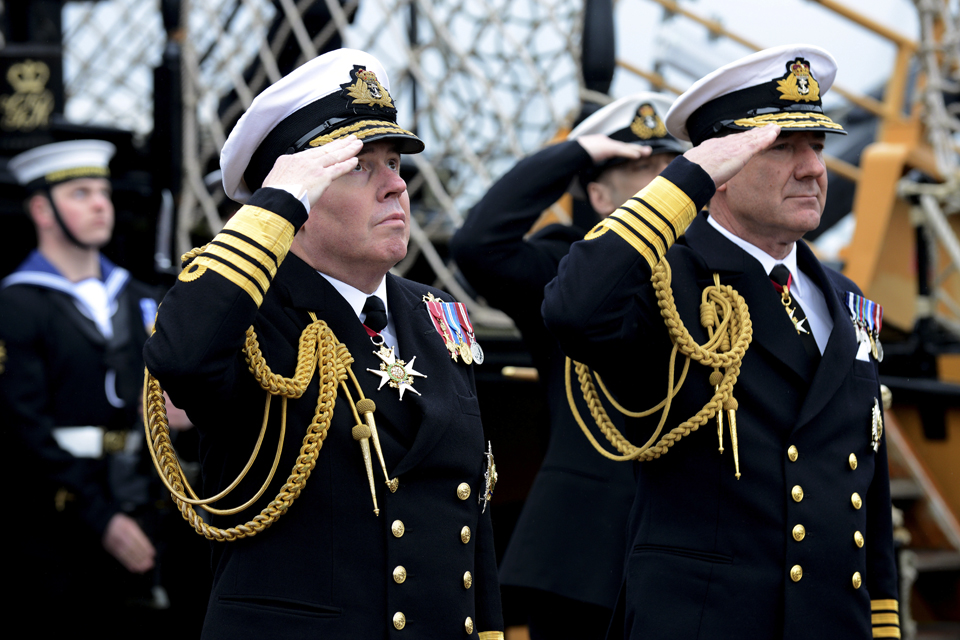 Admiral Stanhope and Admiral Zambellas salute as the Cross of St George flag is lowered