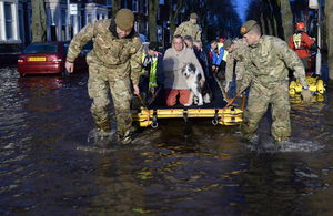 Soldiers from 2nd Battalion The Duke of Lancaster's Regiment help evacuate residents. Crown Copyright.