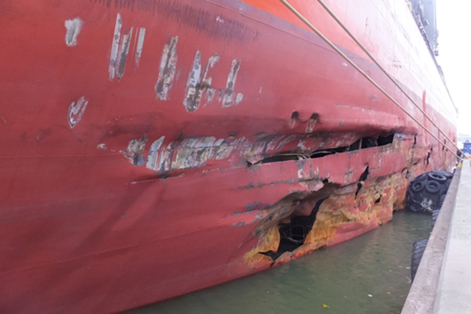 Collision between a cargo ship and an anchored barge