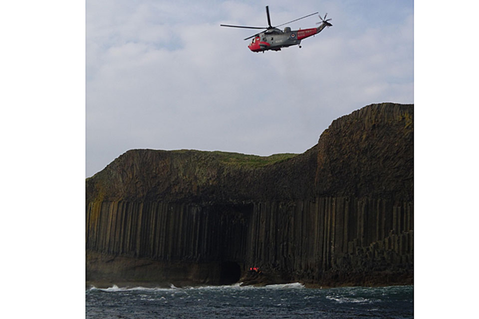 Rescued sightseers are winched aboard HMS Gannet's Sea King helicopter from the rocks below 