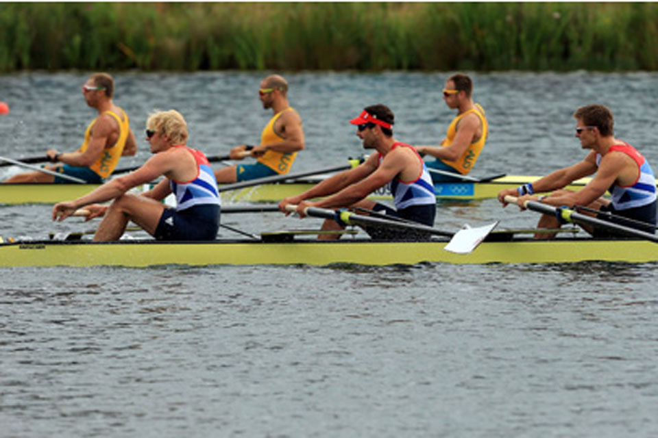 The Team GB Men's Fours team, (left to right) Andrew Triggs Hodge, Tom James, Lieutenant Pete Reed and Alex Gregory, pass the Australian crew to win their semi-final at Eton Dorney Lake near Windsor 