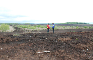 Two people standing on the peatlands at Bolton Fell and Walton Mosses Site of Special Scientific Interest in north Cumbria
