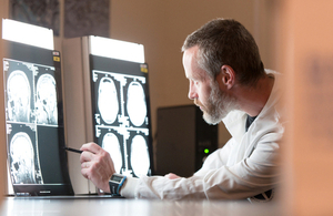 Alzheimer's researcher examining brain scans - courtesy of Alzheimer's Research UK