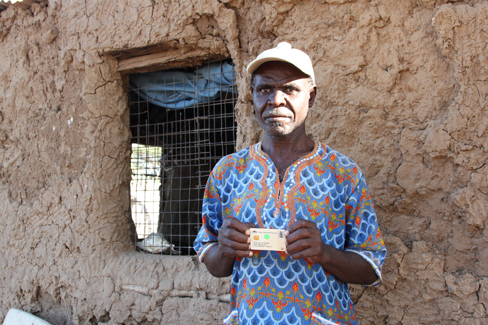 Peter holds the smartcard that ensures he gets the money he's entitled to. Picture: Marisol Grandon/DFID