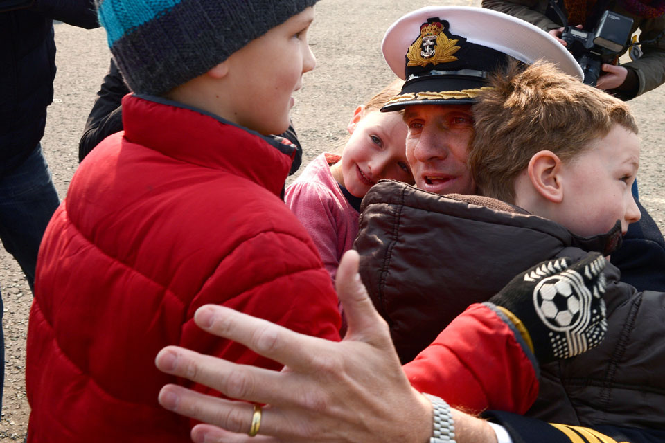 Commander Nick Borbone is greeted by his children