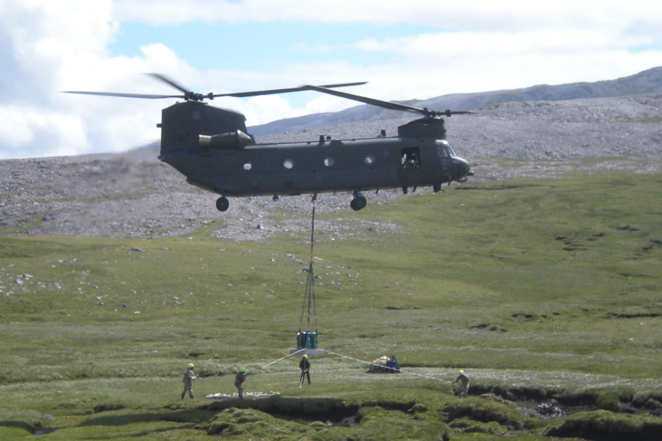 The 600-kilogram granite memorial stone is lowered into place