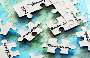 Jigsaw pieces over map of world referring to different languages