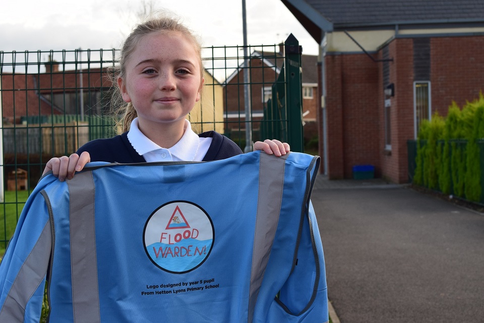 Image shows winner Sally with the new logo design