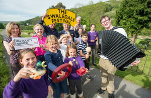 Workers and volunteers for the Swaledale Festival hole up their big society award.